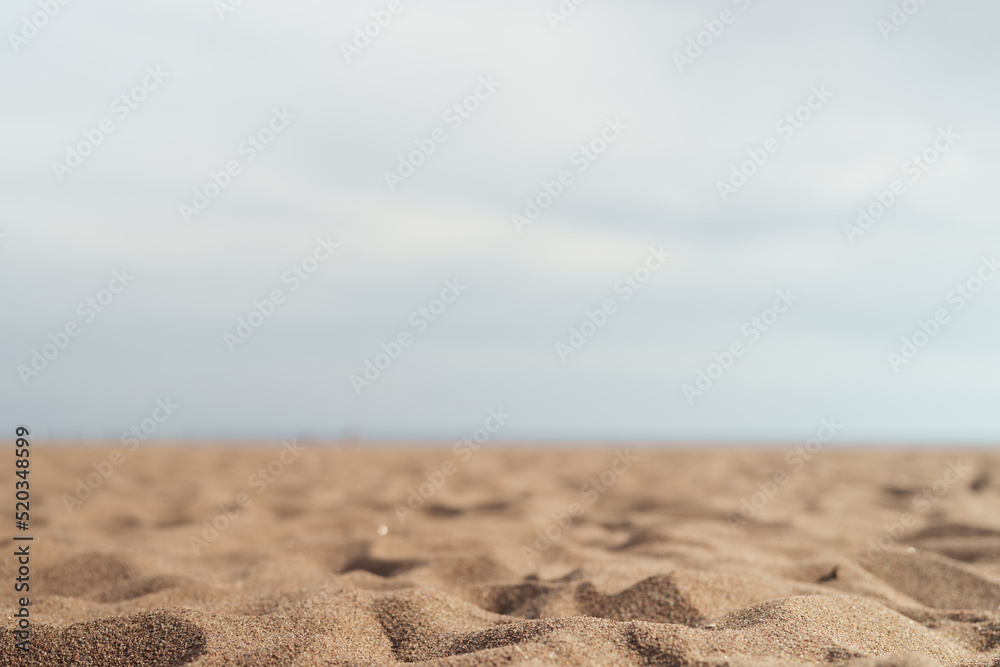 Closeup photo of sandy beach with sea and sky on background Closeup photo of sandy beach with sea and sky on background