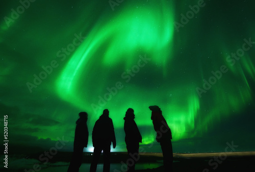 Northern lights over group of friends in Iceland