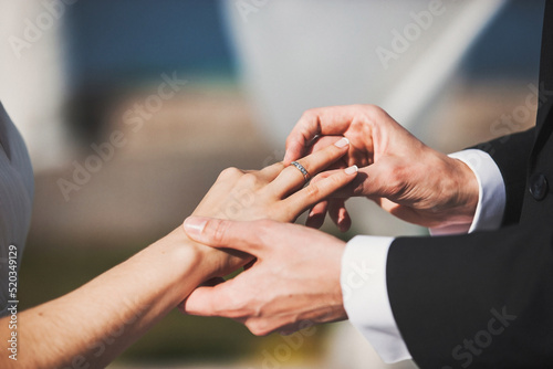 Bride and groom exchange rings at the wedding ceremony