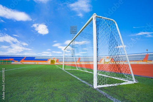 STADIUM - Football field with goal and tablo on blue sky © master_77