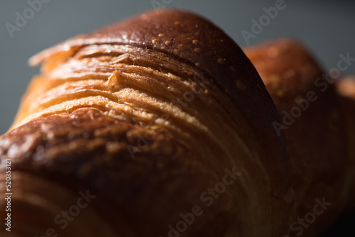 Close up of French croissant on a dark background. 