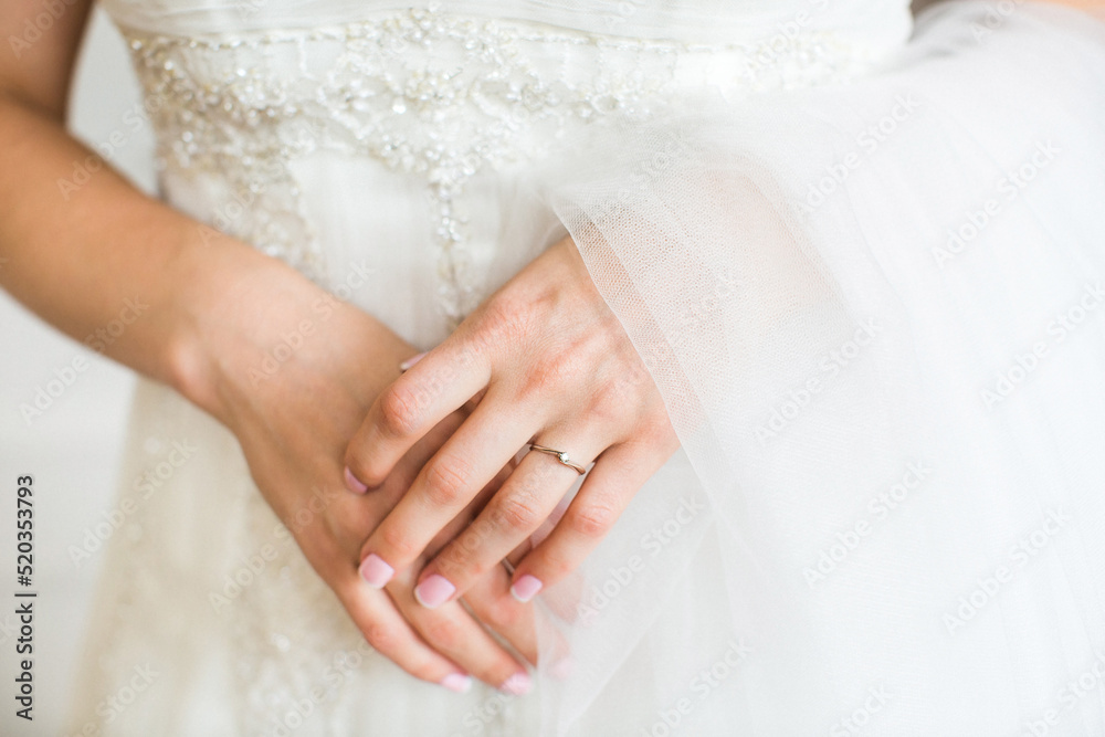 Engagement ring on bride's finger during wedding preparations Engagement ring on bride's finger during wedding preparations