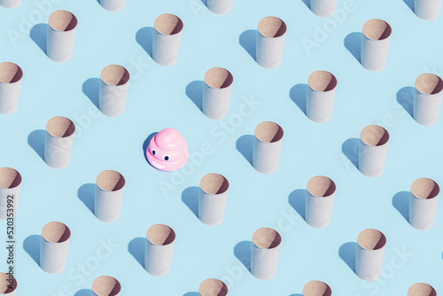 Pattern made of Toilet paper rolls and pink poop emoticon on blue. Isometric. High unexpected demand. Seamless pattern. Break the pattern concept.