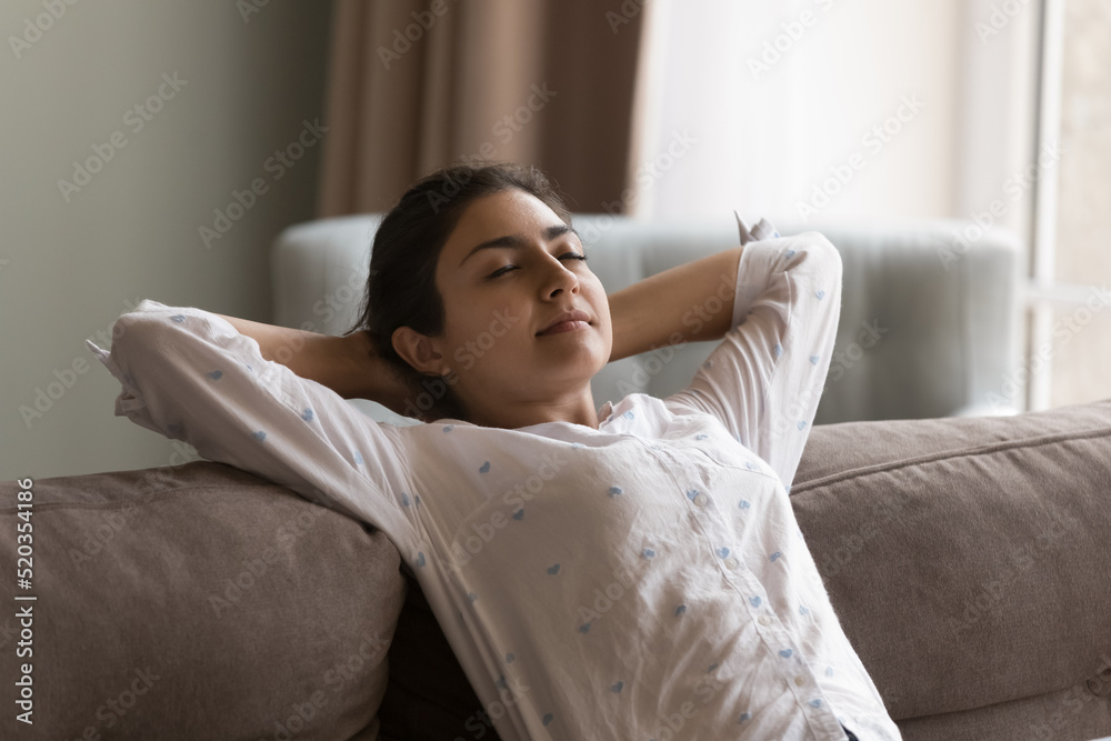 Sleepy peaceful beautiful Indian girl relaxing on sofa, taking deep breath of fresh cool air, enjoying leisure, comfort, chill, practicing meditation, stress relief with closed eyes at home Sleepy peaceful beautiful Indian girl relaxing on sofa, taking deep breath of fresh cool air, enjoying leisure, comfort, chill, practicing meditation, stress relief with closed eyes at home