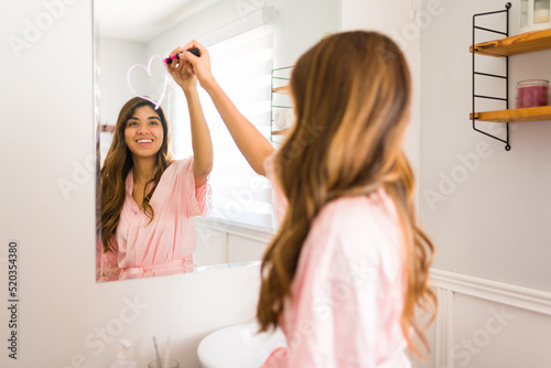 Lovely woman with a good self esteem using a lipstick to draw a heart in the mirror photo