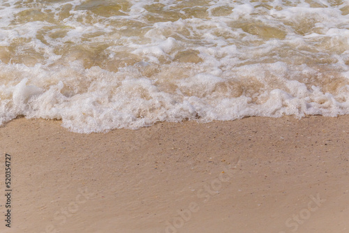 sea waves washing on sandy beach