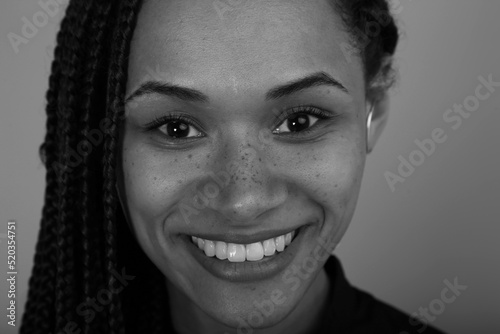 Beautuflul young woman smiling in black and white