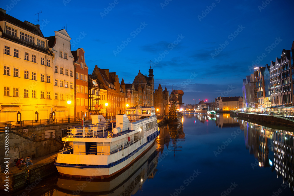 Obraz premium Scenic summer evening panorama of the architectural embankment pier canal river illumination of the Old Town GDANSK, POLAND