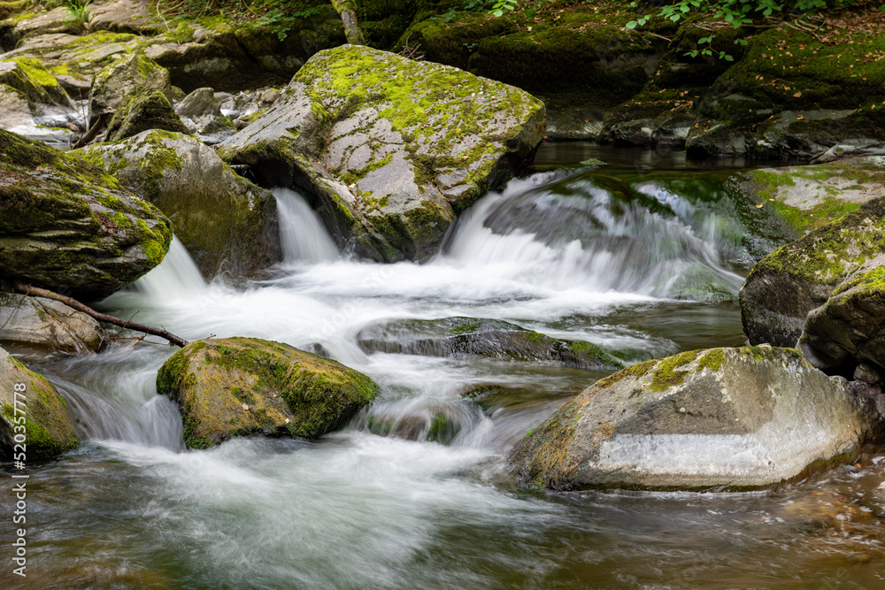 Long exposure of a waterfall on the East Lyn river at Watersmeet in Exmoor National Park Long exposure of a waterfall on the East Lyn river at Watersmeet in Exmoor National Park