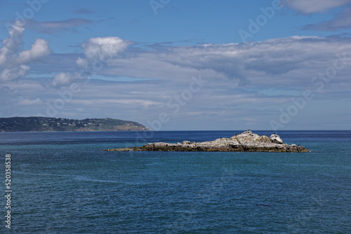 Photography Seascape with rocky island in the calm Irish Sea