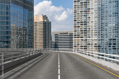 Empty urban asphalt road exterior with city buildings background. New modern highway concrete construction. Concept of way to success. Transportation logistic industry fast delivery. Chicago. USA.