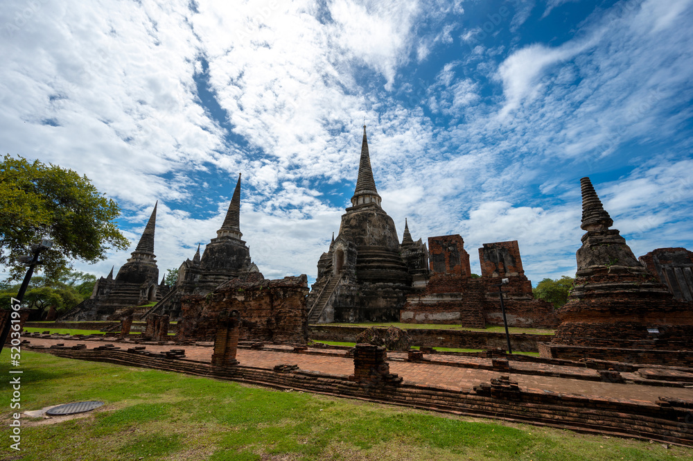 Fototapeta premium Landscape the ruins of ancient city of ayutthaya (Ayutthaya Historical Park) are the famous sightseeing place at Phra Nakhon Si Ayutthaya Province, Thailand. (Public domain)