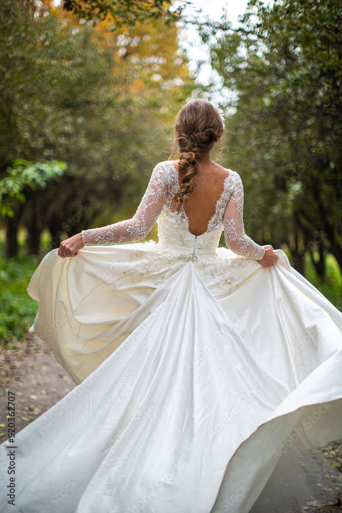 Bride in wedding dress posing in the garden