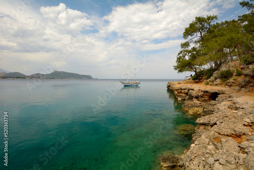 Seascape with a ship and a rocky shore. Türkiye.