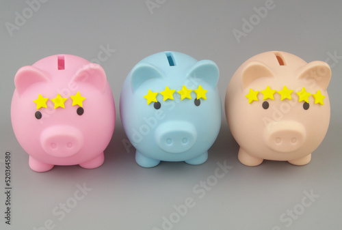 Rating of financial organizations. Three piggy banks with different numbers of stars on gray background.