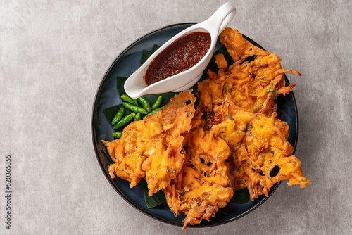 Bakwan is a vegetable fritter or gorengan from Indonesian cuisine.The ingredients are vegetables, usually beansprouts, shredded cabbages and carrots, battered and deep fried in cooking oil. photo