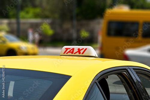 Sign on the roof of a yellow taxi in Greece © Cerib