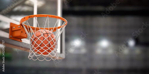 Basketball ball scoring the winning  points on basketball net hoop on basketball arena. © Maksym Yemelyanov