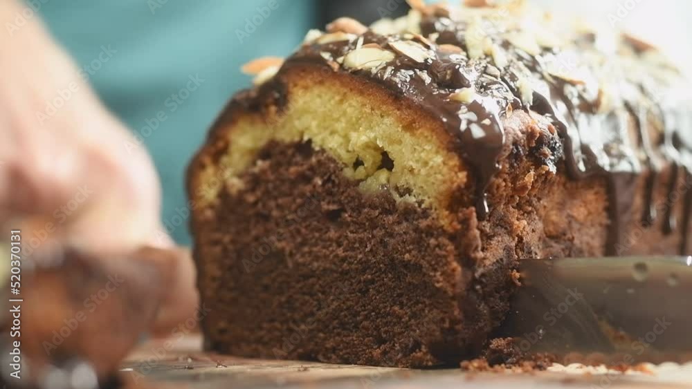 Confectioner slicing three layers chocolate cake.
Confectioner slicing three layers chocolate cake.
