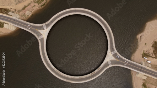 High top down view of the laguna Garzon circular bridge above the deep island flowing water in Uruguay, south America