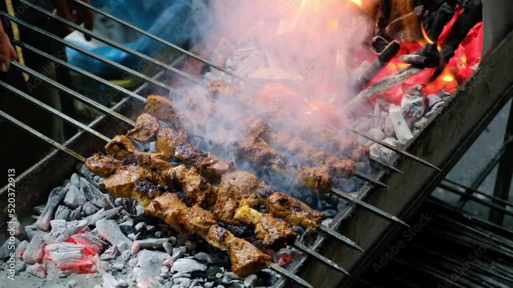 Close-up of kebabs on skewers grilling on brazier. Turkish traditional kebabs grill on coal Close-up of kebabs on skewers grilling on brazier. Turkish traditional kebabs grill on coal