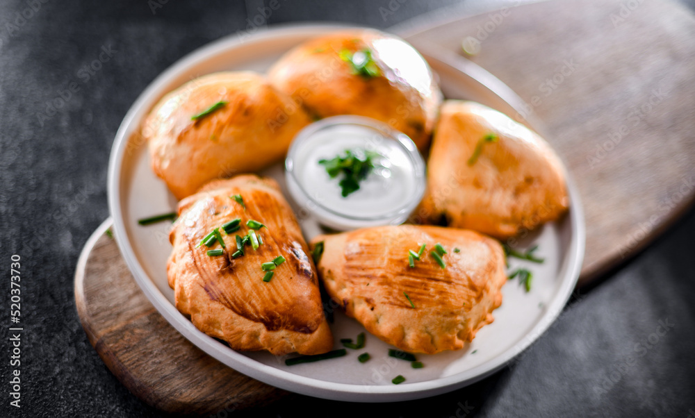 Composition with a plate of oven-baked pierogi