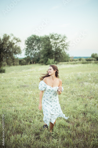 woman in field in nature with a straw hat