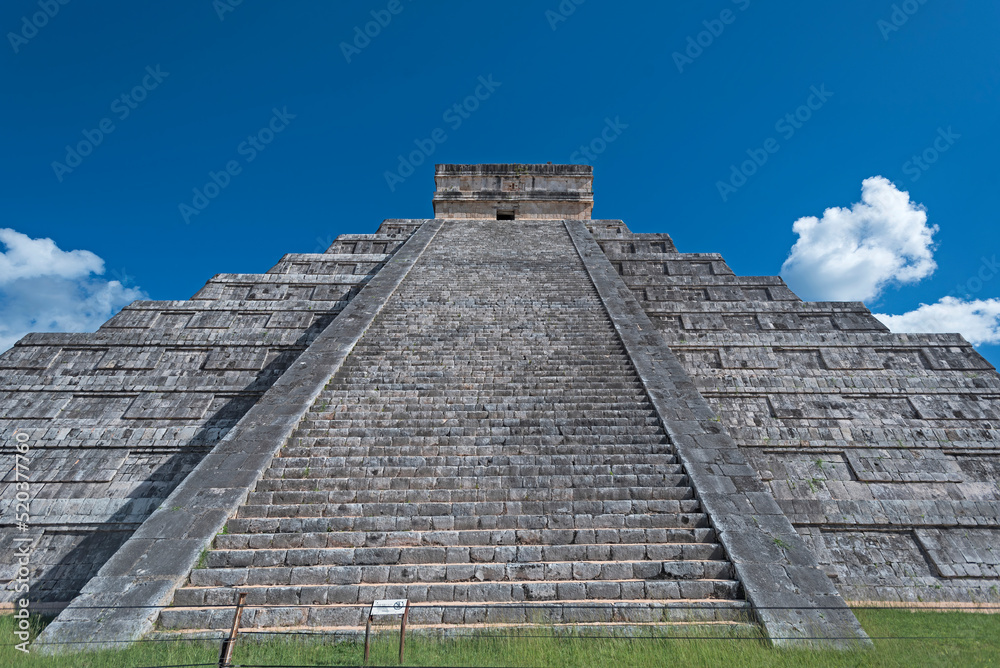 Front view of the Chichen Itza pyramid under a blue sky