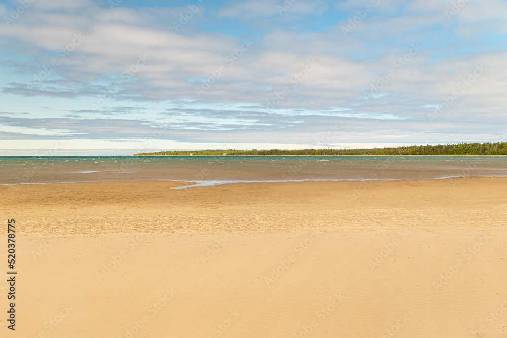 Singing Sands waters landscape, Bruce Peninsula National Park Ontario Canada. Large sandy beach on Lake Huron. White beach named after the sound the wind makes whistling through the dunes.