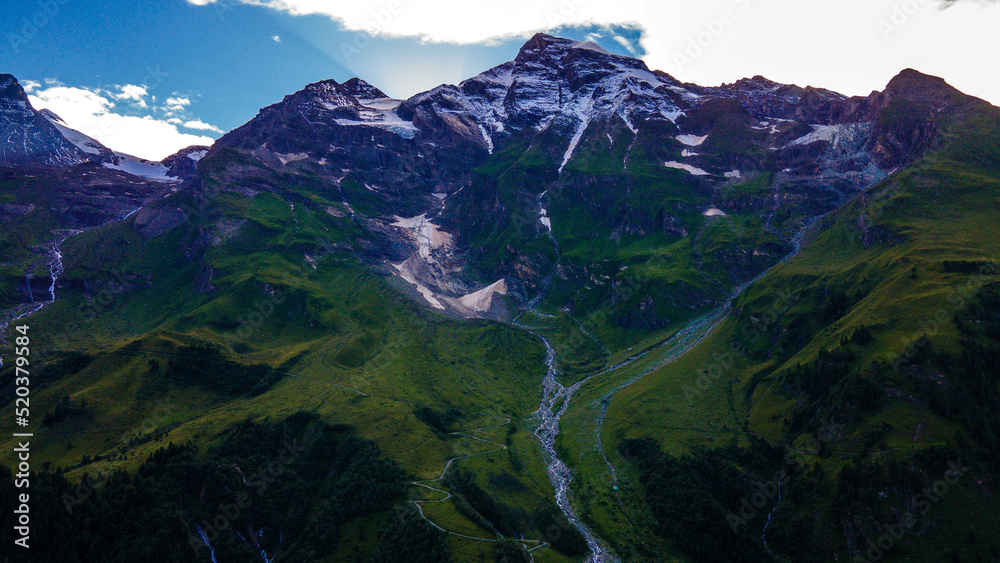 Aerial of Europe Alpes Austria Drone Summer, Scenic view of the Alps with a city down in the valley
