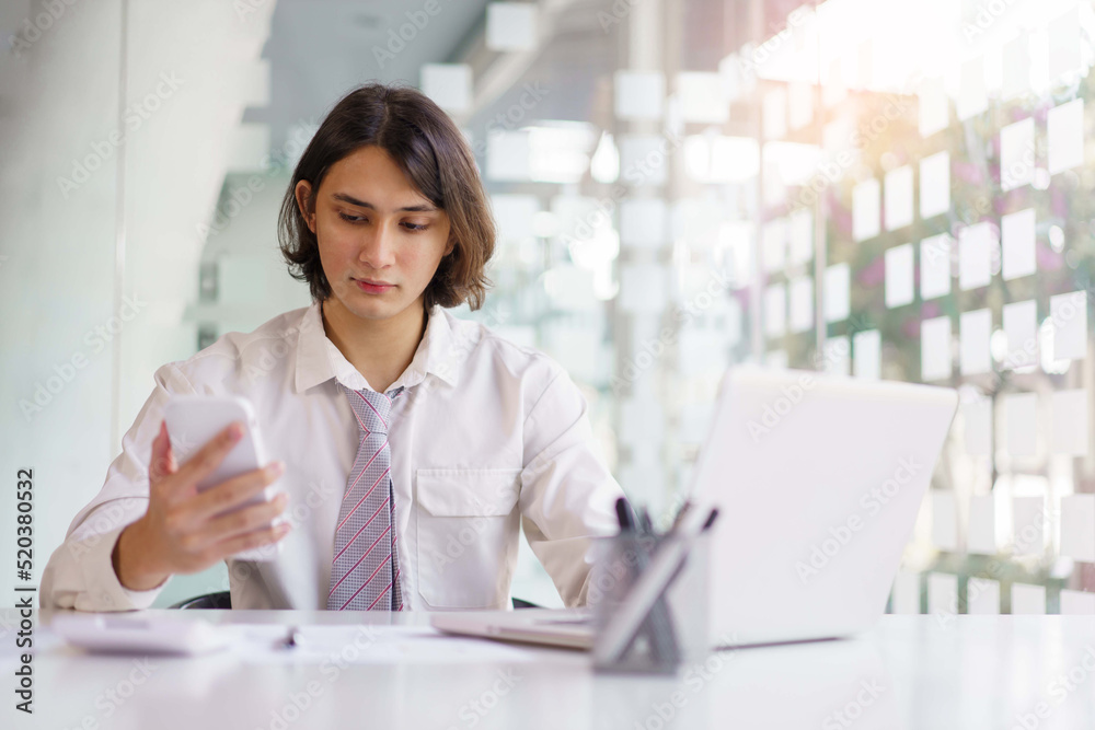 Business concept, Businessman using smartphone to checking financial data and working on laptop Business concept, Businessman using smartphone to checking financial data and working on laptop