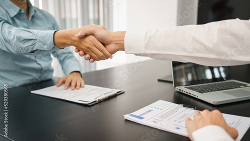 Fototapeta Naklejka Na Ścianę i Meble -  Recruitment concept, Male employer shaking hands with applicant to congratulation for new job