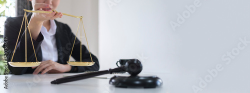 Confident lawyer with small golden justice scale and wooden gavel.  Legal services, advice, justice and law concept.
