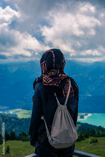 Tourist at Amazing view from Schafberg by St. Sankt Wolfgang im in Salzkammergut, Haus house Schafbergspitze, lake Mondsee, Moonlake. Blue sky, alps mountains. Upper Austria, Salzburg, near Wolfgangse photo