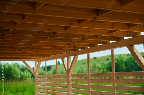 Roof of beams gazebo under a canopy