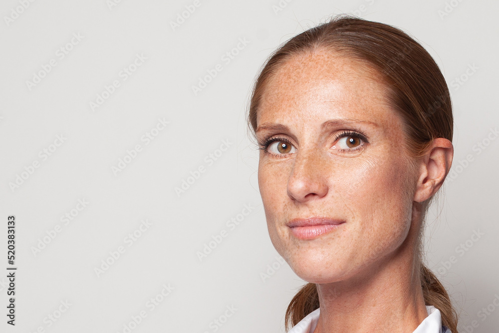 Natural beauty. Portrait of middle-aged woman with freckles closeup Natural beauty. Portrait of middle-aged woman with freckles closeup