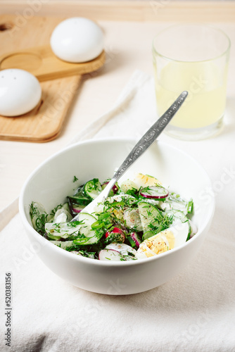 Spring salad with cucumber, radish, and egg.