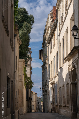 Scenic urban landscape view of typical narrow street and old buildings in the historic center of Montpellier, France in summer