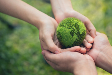 Environment Earth Day In the hands holding green earth on Bokeh green Background, Saving environment, and environmentally sustainable. Save Earth. Concept of the Environment World Earth Day