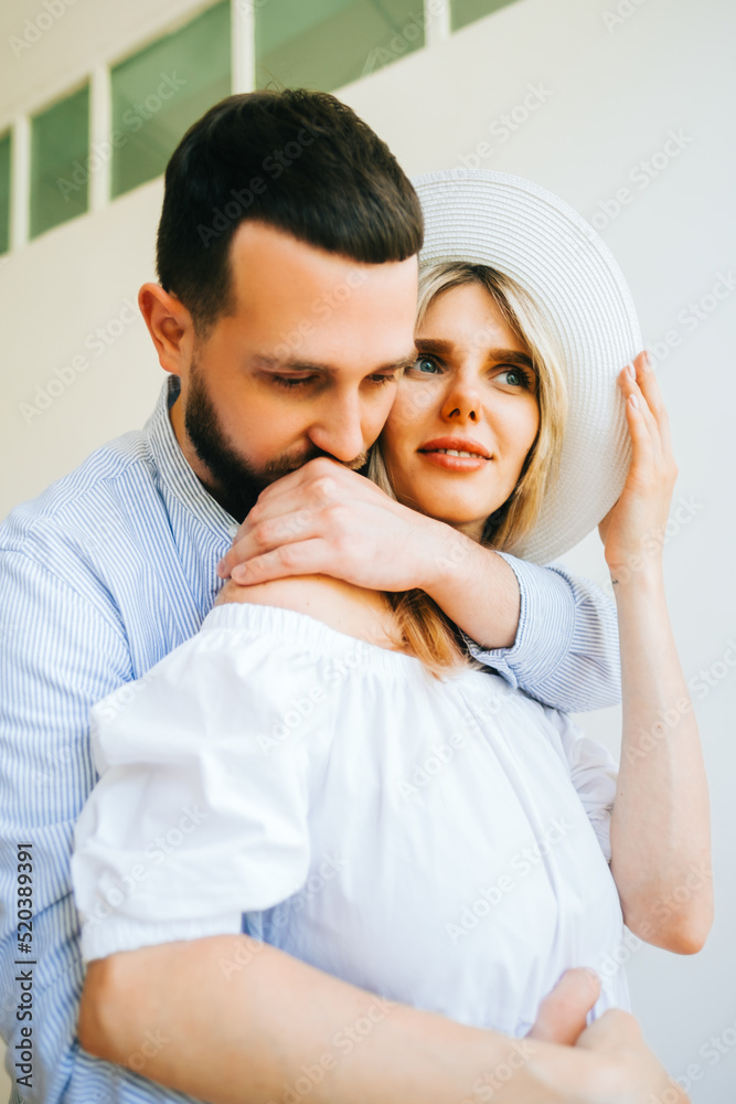 Portrait of future mother and father, husband hug pregnant wife. Happy family resting at home Portrait of future mother and father, husband hug pregnant wife. Happy family resting at home