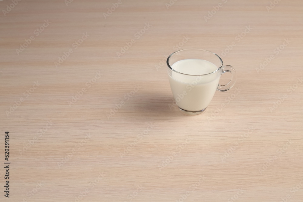 Glass of Fresh Milk on a Wooden Table. Diet Concept. Top Angle View. Glass of Fresh Milk on a Wooden Table. Diet Concept. Top Angle View.