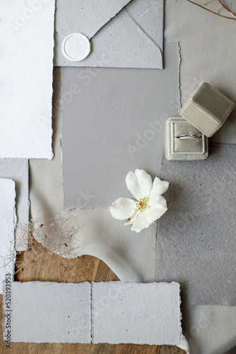 Wedding rings in a box and vintage invitations on the table