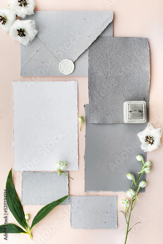 Wedding rings in a box and vintage invitations on the table