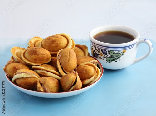 cup of hot coffee and tasty cookies