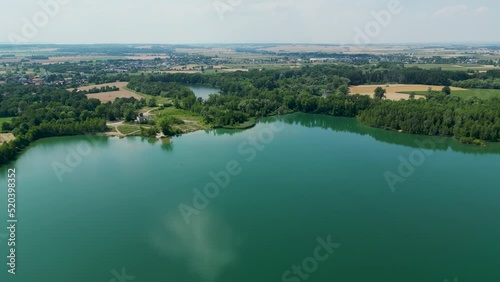 Arial air view on afloat gravel pit named Male Kalisovo jezero lake neat Bohumin city during spring afternoon with blue sky and few clouds photo