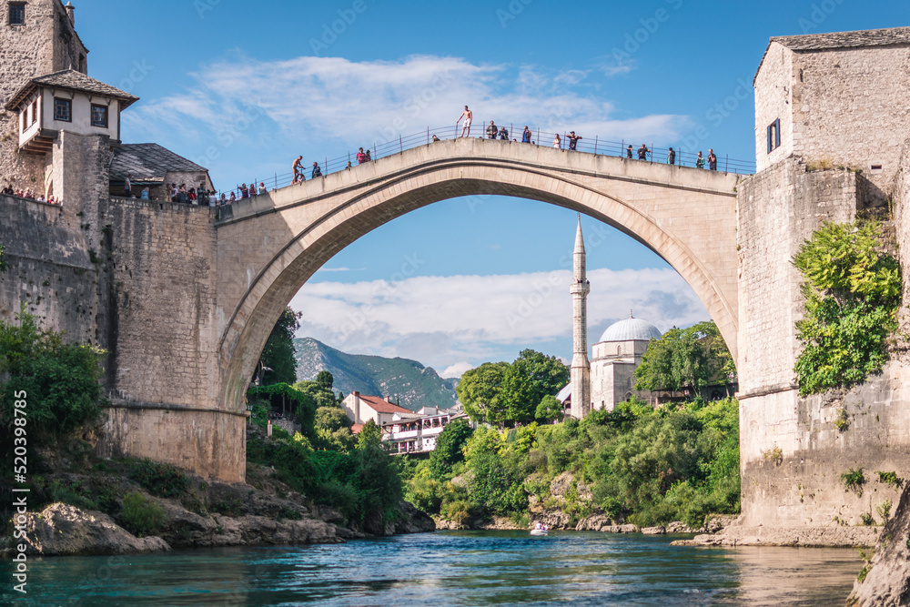 MOSTAR, BOSNIA AND HERZEGOVINA - September 21, 2021: Man is preparing to jump from Stari most, Old Bridge, in Mostar. Bosnia and Herzegovina