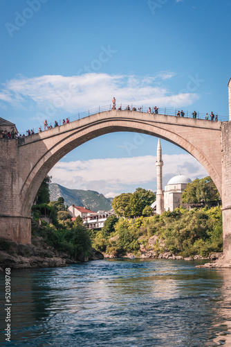 MOSTAR, BOSNIA AND HERZEGOVINA - September 21, 2021: Man is preparing to jump from Stari most, Old Bridge, in Mostar. Bosnia and Herzegovina