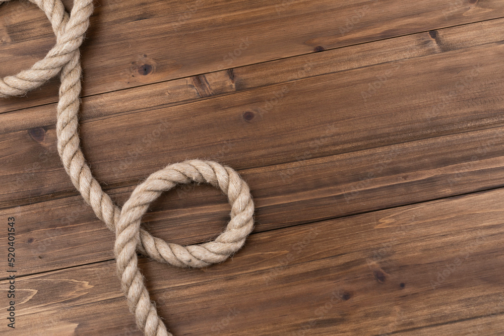 sail boat rope twisted up on wood background. sail boat rope twisted up on wood background.