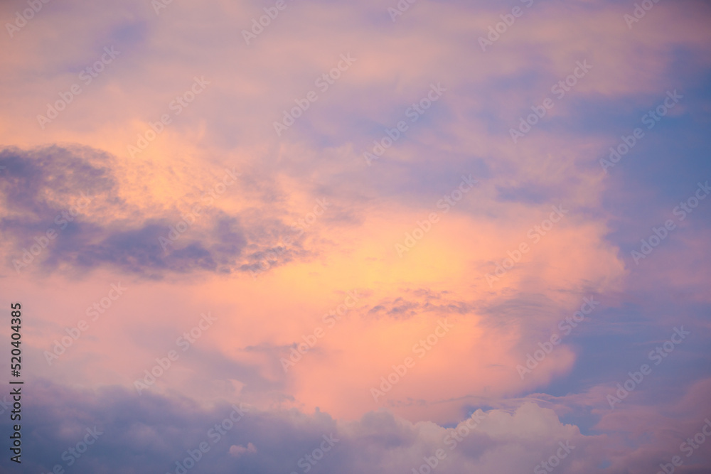Sunset sky with colorful clouds. Blue colors merge with soft orange