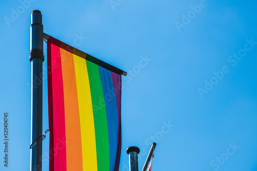 Rainbow flag in front of clear blue sky with a lot of copyspace- LGTB- diversity